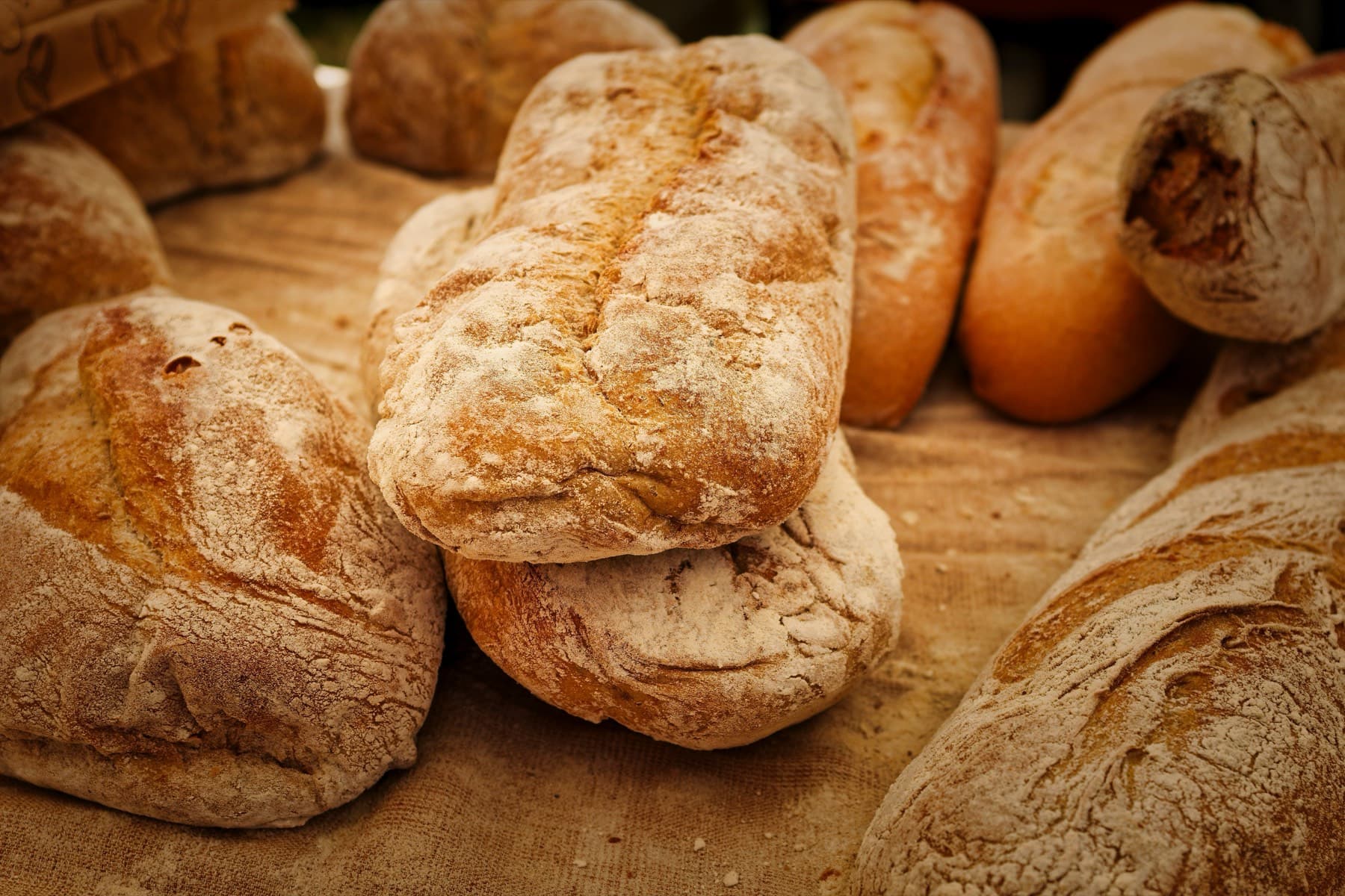 Floury loaves of bread on a linen cloth